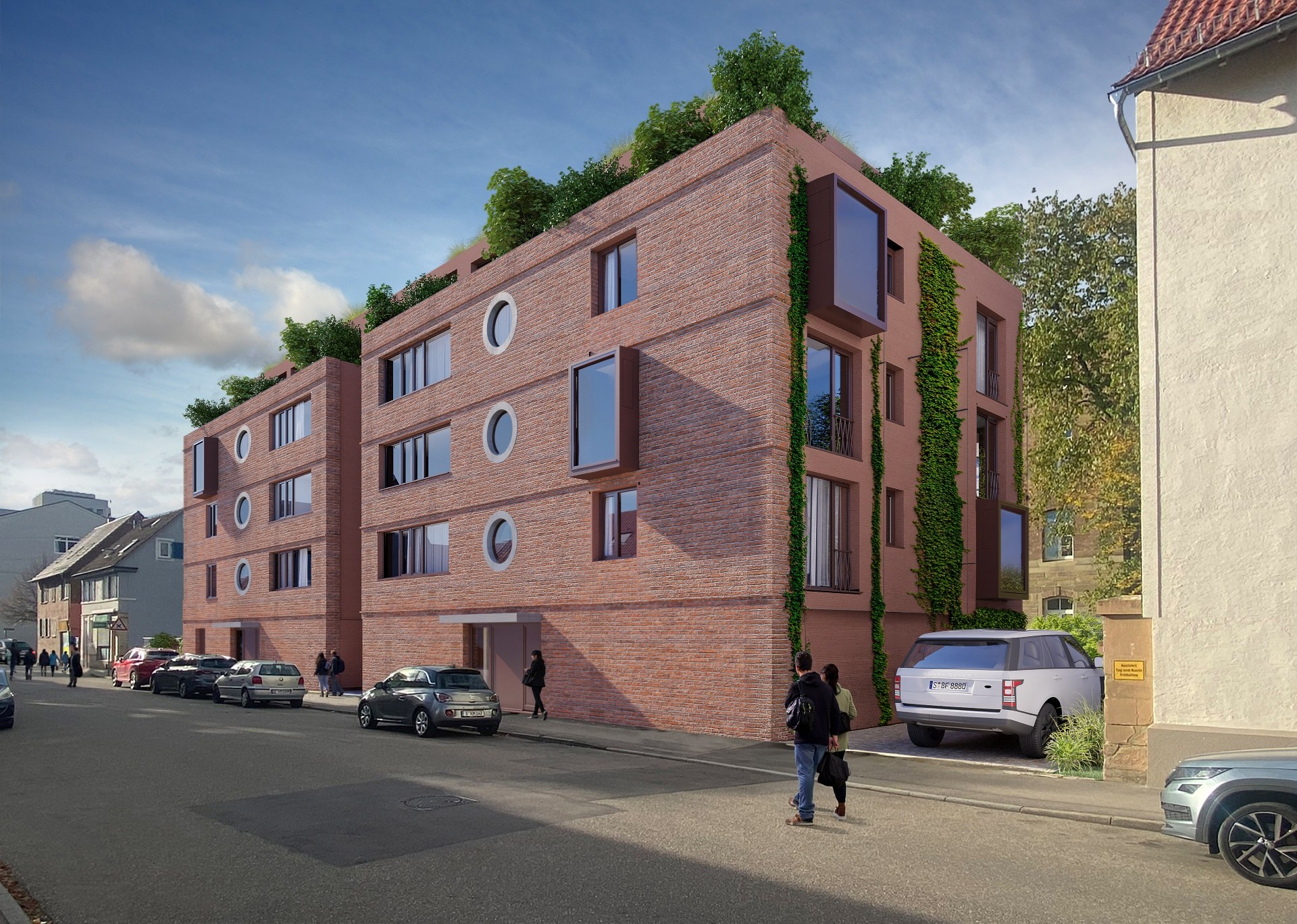 Tagesansicht der verklinkerten Fassade mit runden Bullaugen-Fenstern und begrünten Dachterrassen